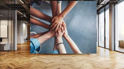 Stack of hands showing unity and teamwork Wall mural