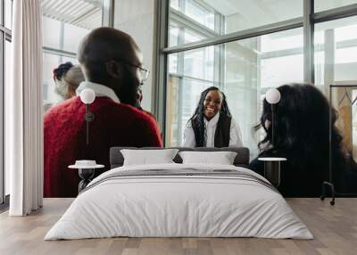 Successful black woman engaging with colleagues in a corporate meeting Wall mural