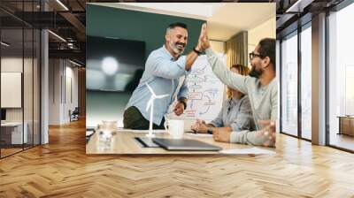 Successful businessmen high fiving each other during a meeting Wall mural