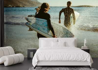 Surfers going for water surfing Wall mural