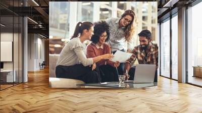 Team of coworkers looking at a business paper Wall mural