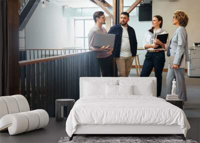 Tech professionals having a standup meeting in an office Wall mural