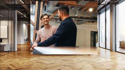 Two business men talking to each other about their tech work Wall mural