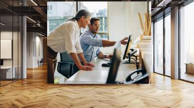 Two business people working together in office Wall mural