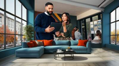 Two businesspeople using a digital tablet in a boardroom Wall mural