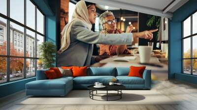 Two businesswomen having a discussion in a modern office Wall mural