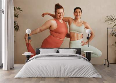 Two women exercising together at health club Wall mural