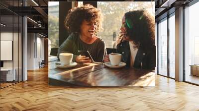 Two women having fun at a coffee shop Wall mural