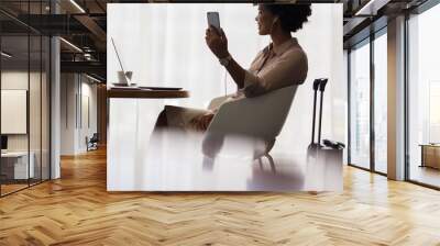 Woman at airport lounge making video call Wall mural