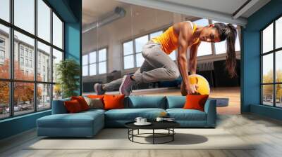 woman doing intense core workout in gym Wall mural