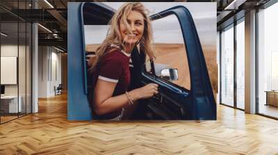 Woman enjoying herself on road trip Wall mural