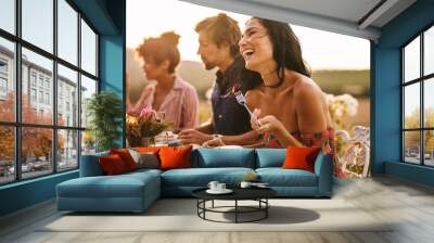 Woman enjoying with friends at outdoor dinner party Wall mural