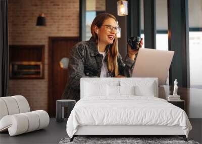 Woman enjoying working from a coffee shop Wall mural