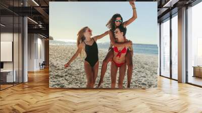 Woman friends enjoying on beach Wall mural