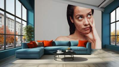 Woman frustrated about skin problems Wall mural