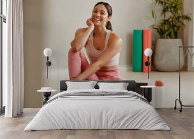 Woman taking a break from yoga session at gym Wall mural