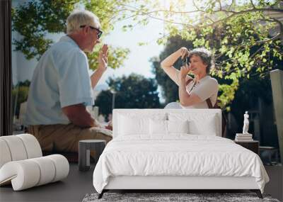 Woman taking pictures of her husband Wall mural