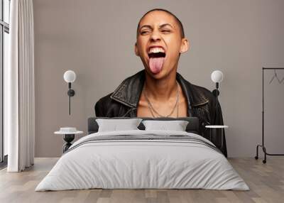 Woman with shaved head sticking out her tongue Wall mural