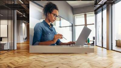 Woman working at her desk Wall mural