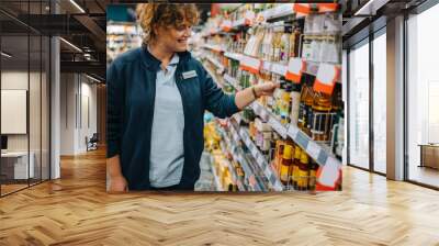 Woman working in supermarket Wall mural