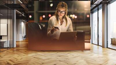 Woman working late in office Wall mural