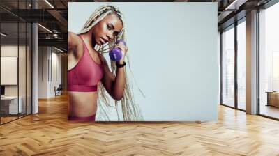 Woman working out with dumbbells Wall mural