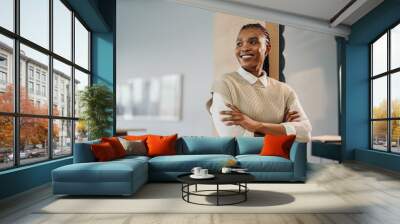 Young African female entrepreneur looking pensive in a corporate office Wall mural