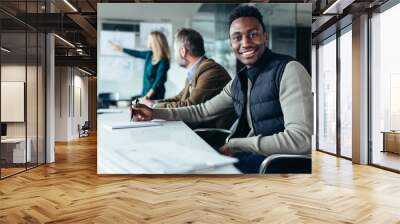 Young businessman sitting in conference room Wall mural