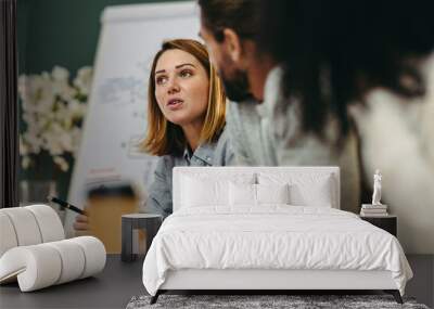 Young businesswoman having a discussion with her colleagues in a meeting Wall mural