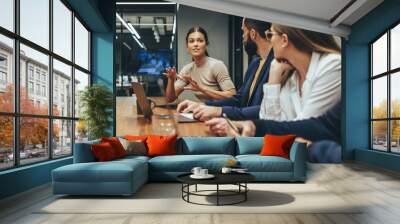 Young businesswoman leading a discussion during a meeting Wall mural