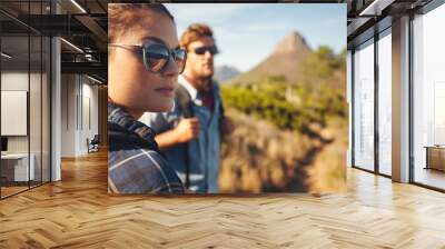 Young couple hiking in countryside Wall mural