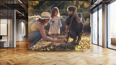 Young family working together in their farm Wall mural