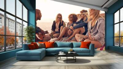 Young friends enjoying a beach party Wall mural