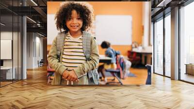 Young male student smiling and looking at camera on first day of co-ed class Wall mural