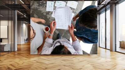 Young people going through financial documents in office Wall mural