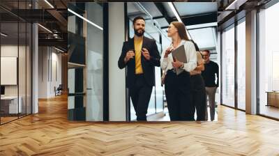 Young professionals having a discussion in an office Wall mural