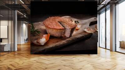 Homemade, baked meat pate. Rustic composition with cut pate on a wooden chopping board, on a black background. Wall mural