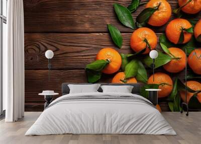 Fresh mandarin oranges fruit or tangerines with leaves on rustic wooden table, top view. Flat lay. Copyspace Wall mural