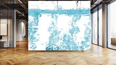 Drinking water pouring into clear glass. Bubbles inside from pouring falling clear water. Drinking soda water flush air bubble. White background isolated freeze element Wall mural