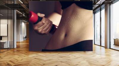 Fitness Model Lady woman sweaty sporty belly stomach after heavy exercise, working office girl workout sweat with dumbbell weight loss concept, dark studio background, black and white style Wall mural