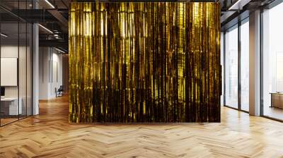 Gold Foil strip Curtain hanging on wall with studio lighting, Golden decorate Wallpaper Background Texture Detail with yellow reflect shinning for celebrating New Year or anniversary party concept Wall mural