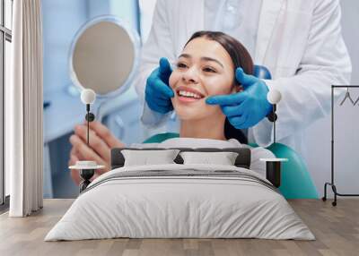 Dentist, mirror and woman check smile after teeth cleaning, braces and dental consultation. Healthcare, dentistry and happy female patient with orthodontist for oral hygiene, wellness and cleaning Wall mural