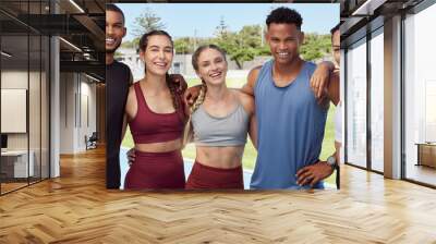 Portrait of diverse group of athletes standing together and smiling after practice. Young, happy, fit, active sports team bonding in training sports centre. Athletic people after exercise and workout Wall mural