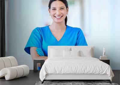 Woman, nurse and portrait with arms crossed and smile in a hospital and clinic. Employee, healthcare and wellness professional with happiness and confidence from doctor and medical work and care Wall mural