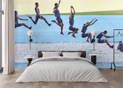 A sequence of a fit male athlete jumping in a sandpit competing in the long jump. Professional athlete or track racer during long or triple jump attempt is a competitive sports event or training Wall mural