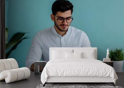 Modern Young Businessman Working on Laptop at Minimalist Desk Wall mural