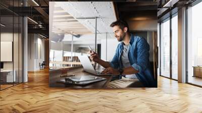 Man in coffee shop, laptop and smartphone, small business and entrepreneur in hospitality industry and connect. Male owner, cafe franchise and check email or social media with digital admin on pc Wall mural