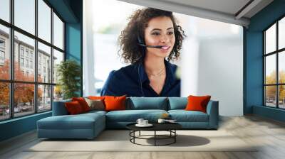 shes determined to help as many customers as possible. cropped shot of an attractive young female ca Wall mural