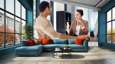 Getting her point across. Shot of two businesspeople having a discussion in an office. Wall mural