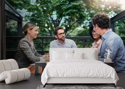 Location, location, location. Cropped shot of a group of business colleagues having a meeting outdoors at a cafe. Wall mural